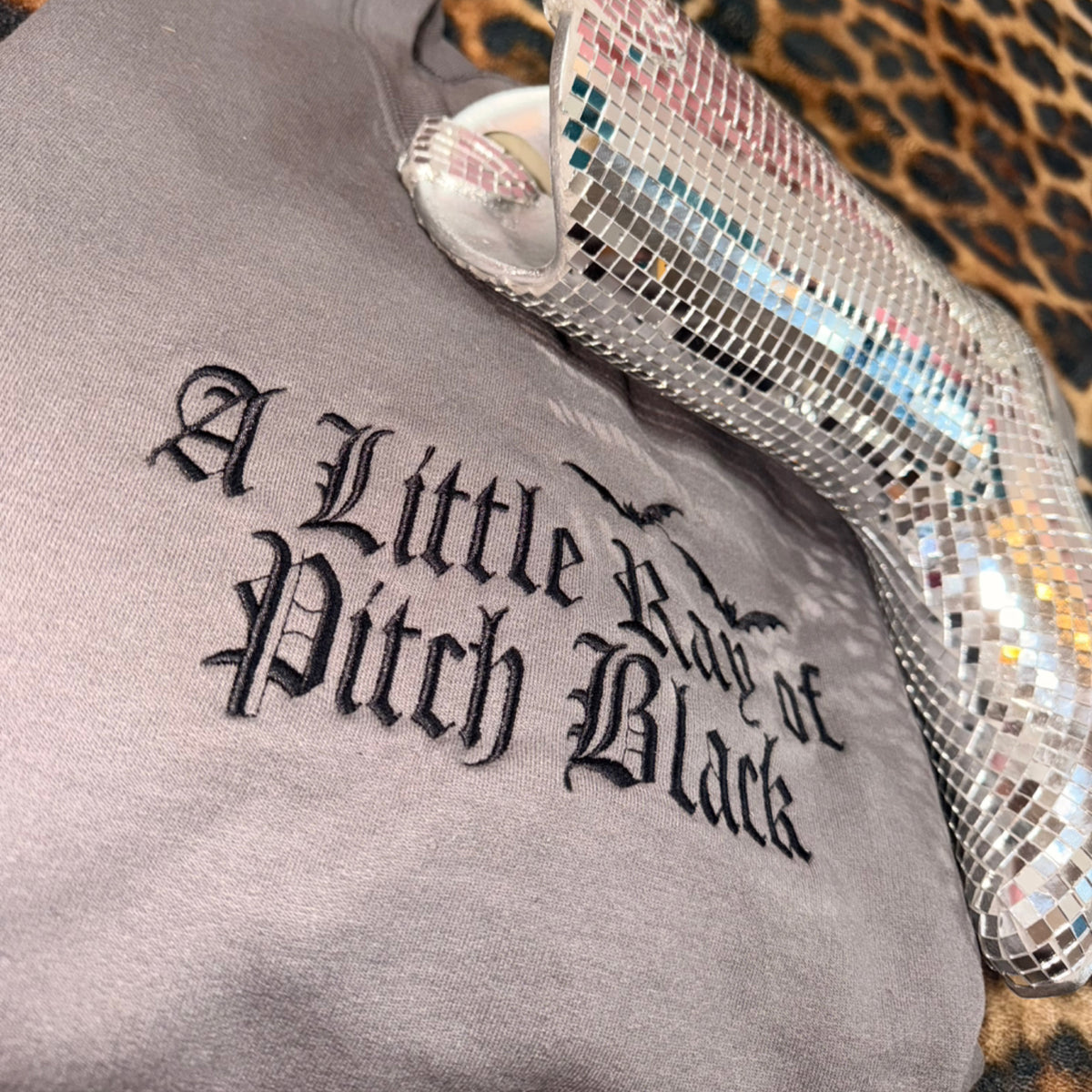 “A little ray of pitch black” embroidered sweatshirt